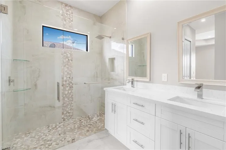 Bathroom featuring vanity and an enclosed shower