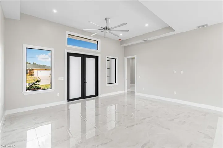 Foyer entrance with ceiling fan and french doors