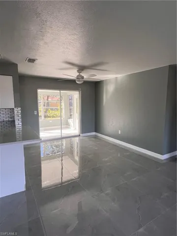 Spare room featuring ceiling fan and a textured ceiling
