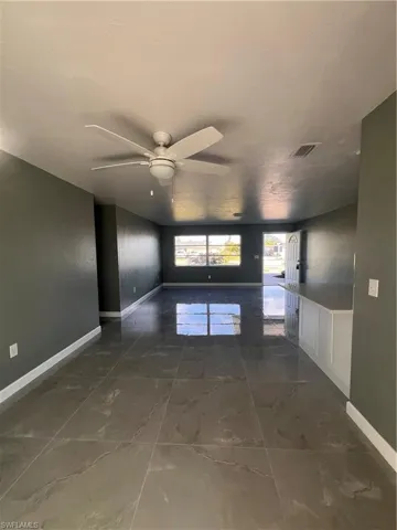 Unfurnished room featuring ceiling fan