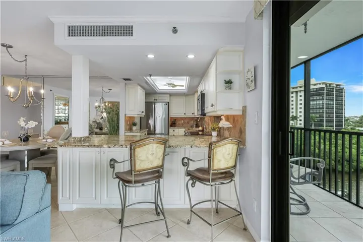 Kitchen featuring white cabinetry, granite countertops, and stainless steel appliances