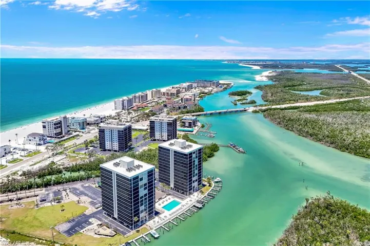 Coastal high-rise properties with direct access to a private marina, community pool, and Gulf beaches