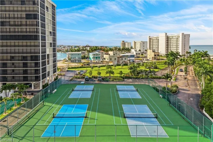 Multiple recreational courts with vibrant green and blue surfaces, surrounded by fencing
