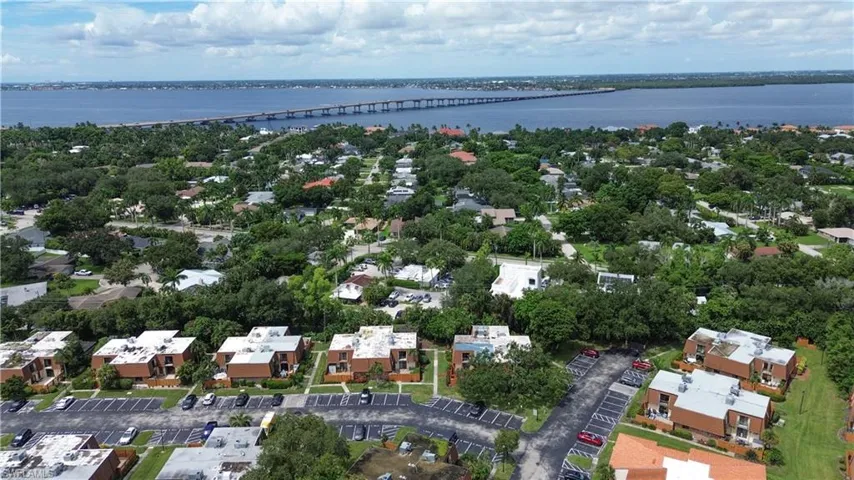 Aerial view of residential area featuring a notable bridge and a nearby body of water