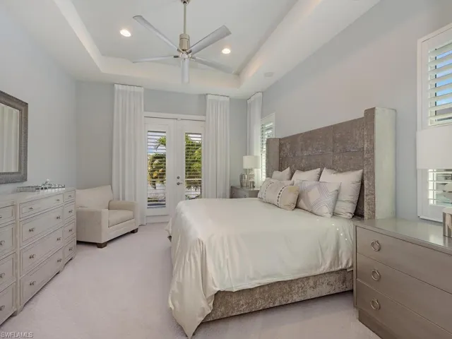 Master bedroom with French doors leading to screened Lanai, pool and spa.