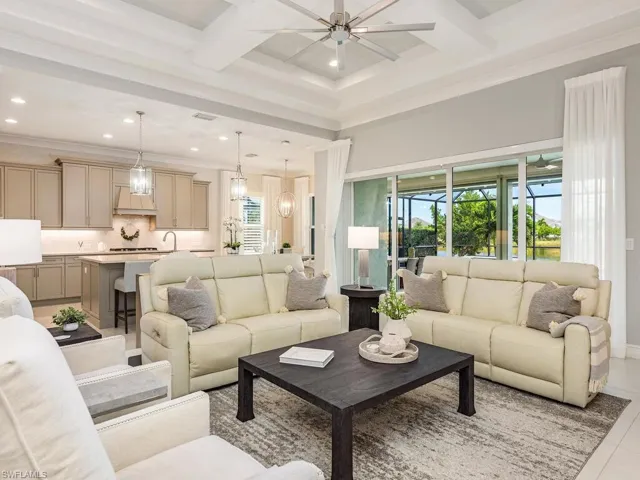 Partial living room view overlooking kitchen, dining nook and covered lanai.