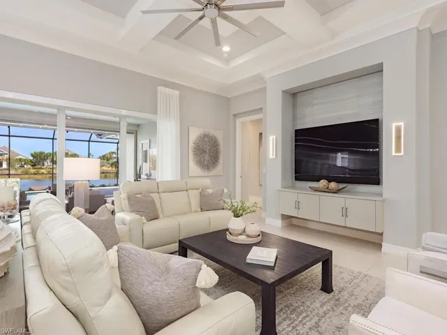 Furnished Living Room with high coiffured ceiling.