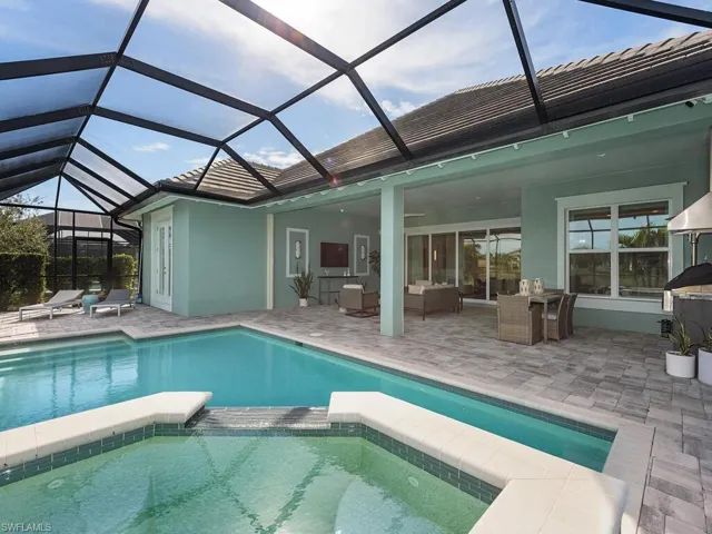 Screened lanai with view from spa overlooking pool and covered lanai.