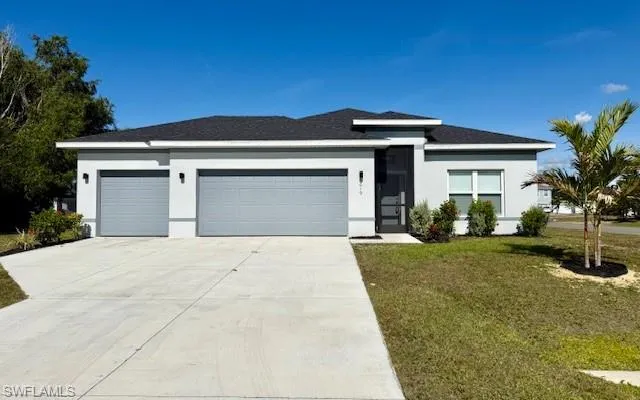 View of front facade featuring stucco siding, a front lawn, an attached garage, and concrete driveway