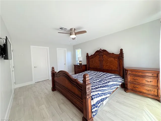 Bedroom with wood tiled floors and ceiling fan
