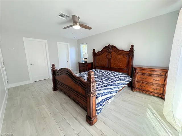 Bedroom with wood tiled floors and ceiling fan