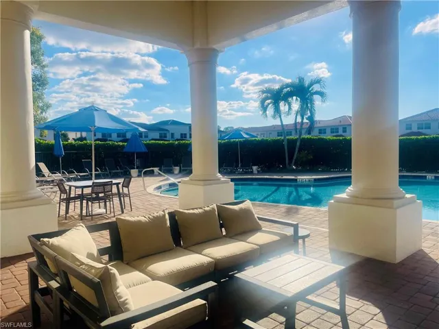 Community pool with a patio area and an outdoor hangout area