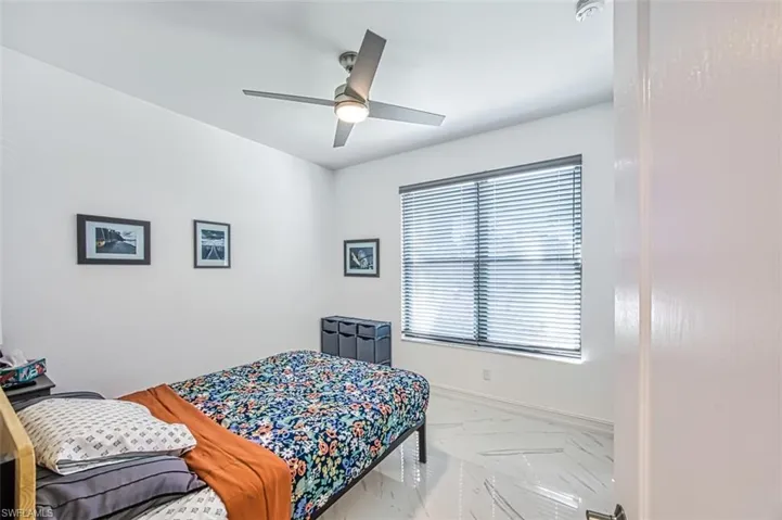 Bedroom with multiple windows and ceiling fan