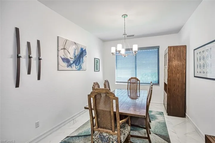 Dining space featuring a chandelier and light tile floors
