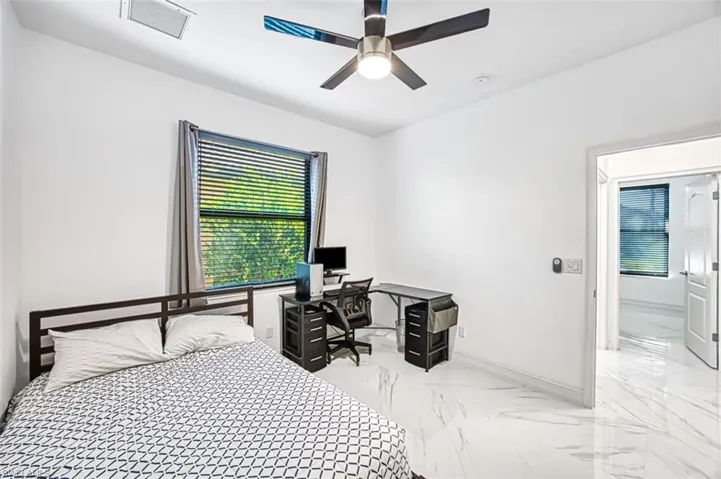 Bedroom featuring ceiling fan and light tile flooring