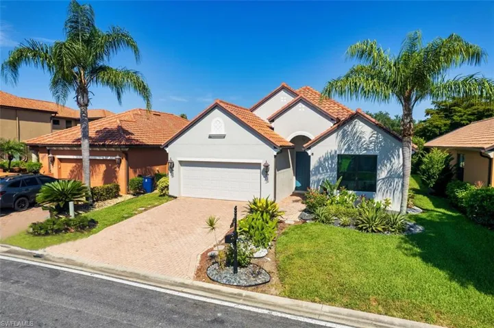 View of front of property with a garage and a front yard