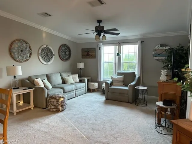 Living room with vaulted ceiling and crown molding