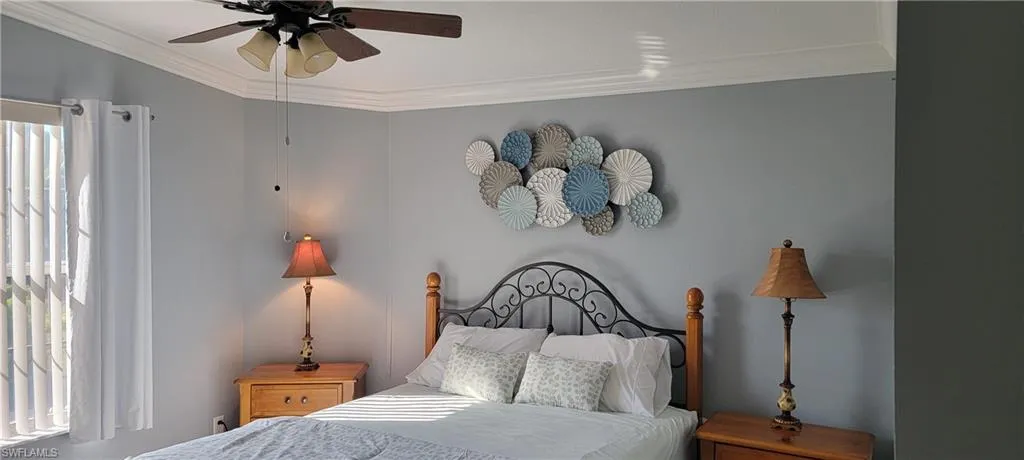 Bedroom with ceiling fan and crown molding