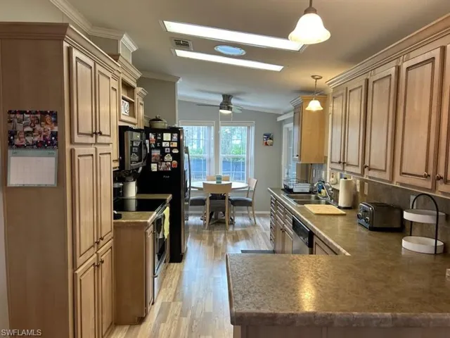Kitchen featuring stainless steel appliances  and  vaulted ceiling
