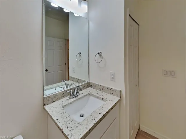 photo is of a previously completed home  Bathroom featuring vanity
