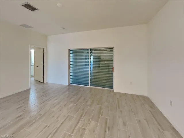 photo is of a previously completed home  Empty room with light hardwood / wood-style floors
