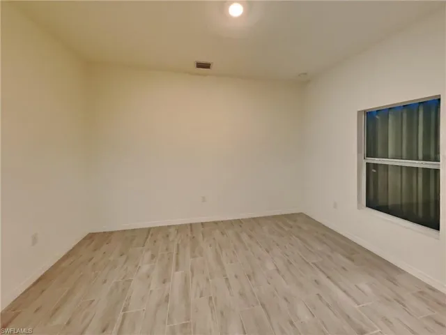 photo is of a previously completed home  Empty room with light hardwood / wood-style flooring