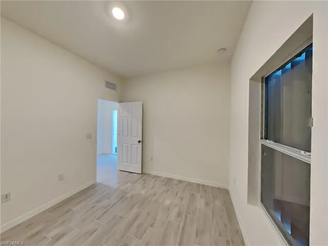 photo is of a previously completed home  Spare room with light hardwood / wood-style floors