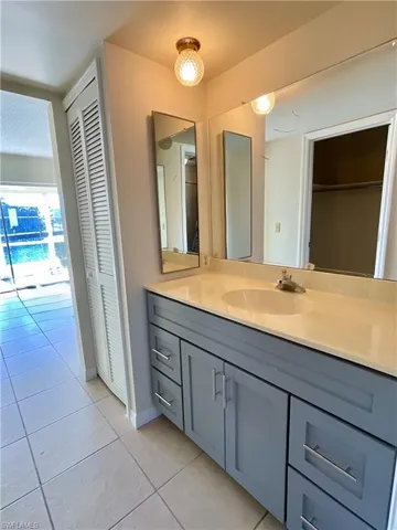 Bathroom with tile patterned floors and vanity