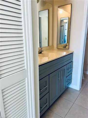 Bathroom with tile patterned floors and vanity