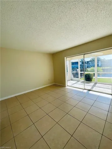Primary bedroom room with a water view and a textured ceiling