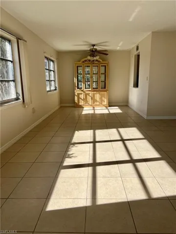 Tiled greatroom room with ceiling fan and a healthy amount of sunlight