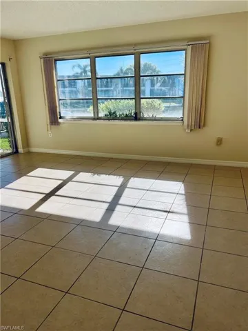 Tiled living room featuring a textured ceiling