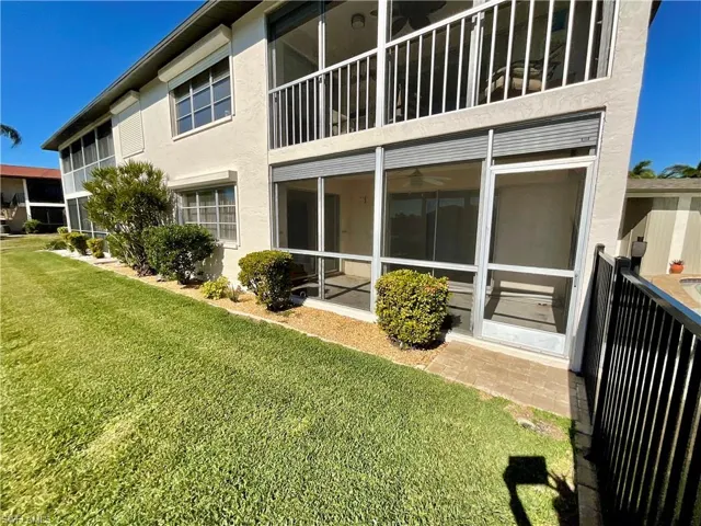 Rear view of property featuring a lawn