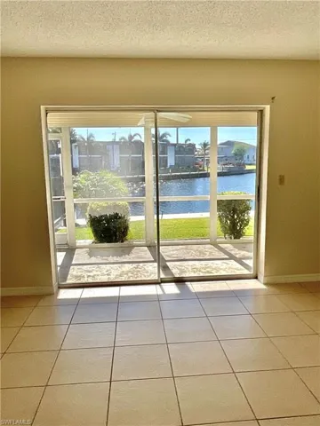 Primary bedroom patterned flooring, a water view, and plenty of natural light