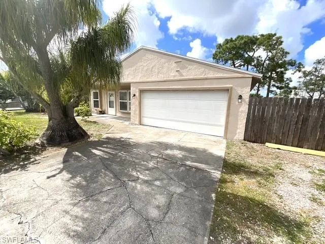 Single story home featuring stucco siding, concrete driveway, and a garage