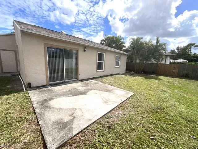 Rear view of property with a patio, stucco siding, and a fenced backyard