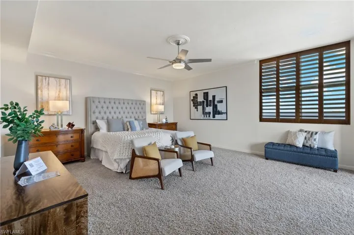 Bedroom with ceiling fan and carpet flooring