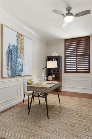 Home office featuring crown molding, light hardwood / wood-style flooring, and ceiling fan