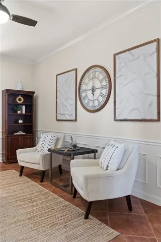 Sitting room featuring ceiling fan and ornamental molding