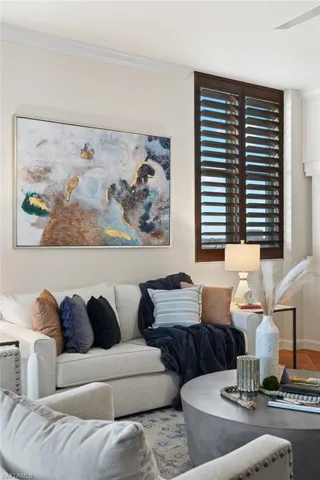 Living room featuring tile patterned floors and ornamental molding
