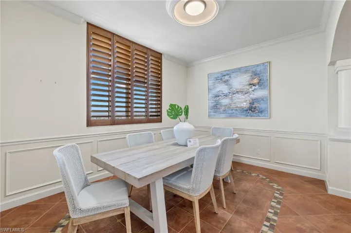 Tiled dining space with crown molding