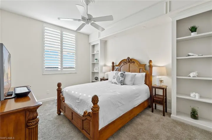 Carpeted bedroom with ceiling fan