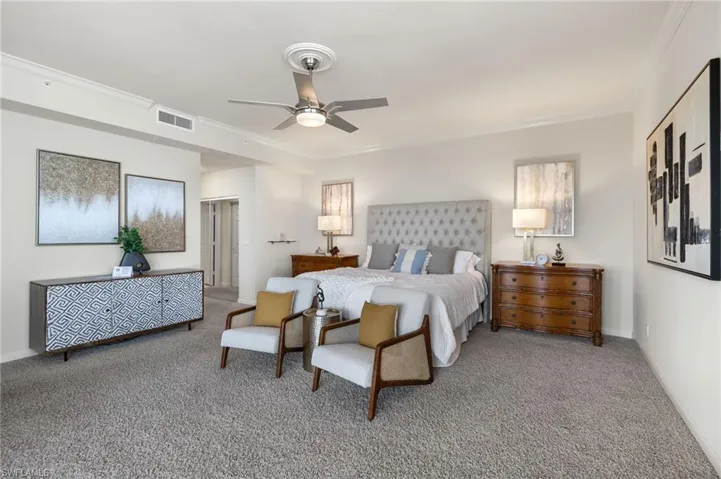 Bedroom with carpet flooring, crown molding, and ceiling fan