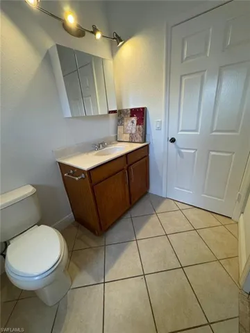Bathroom with vanity, tile patterned flooring, and toilet