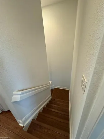 Stairs with hardwood / wood-style flooring