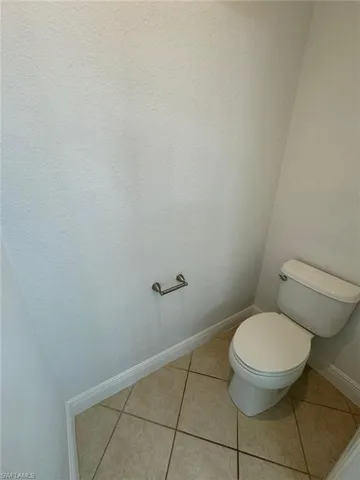 Bathroom featuring toilet and tile patterned floors