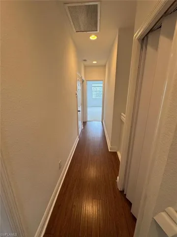 Hallway with dark wood-type flooring