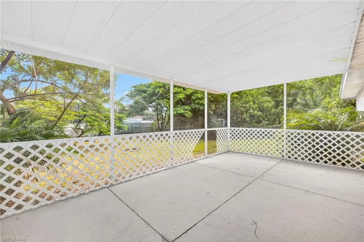 Unfurnished sunroom with a patio area