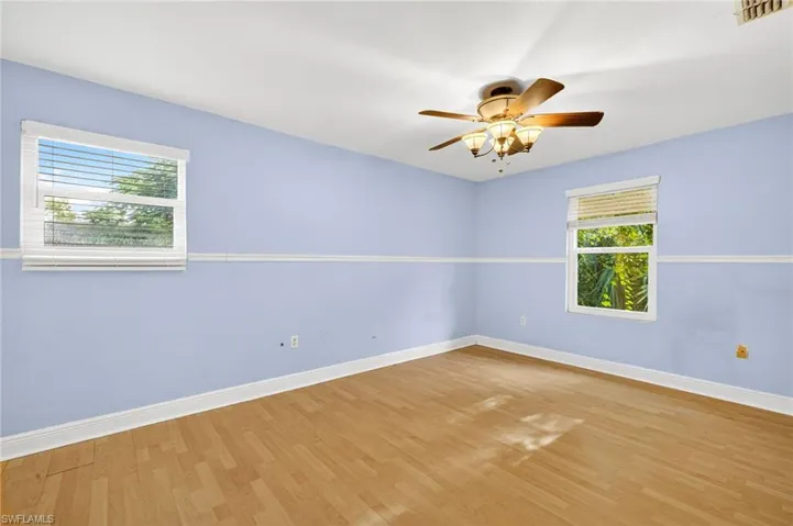Empty room featuring wood finished floors and ceiling fan