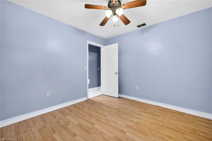Spare room with wood finished floors and ceiling fan